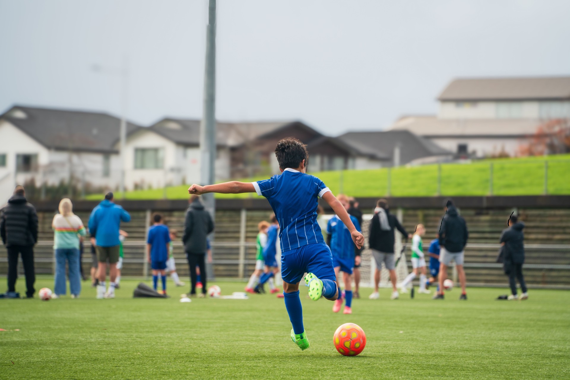 Boy athlete executing a goal shot.