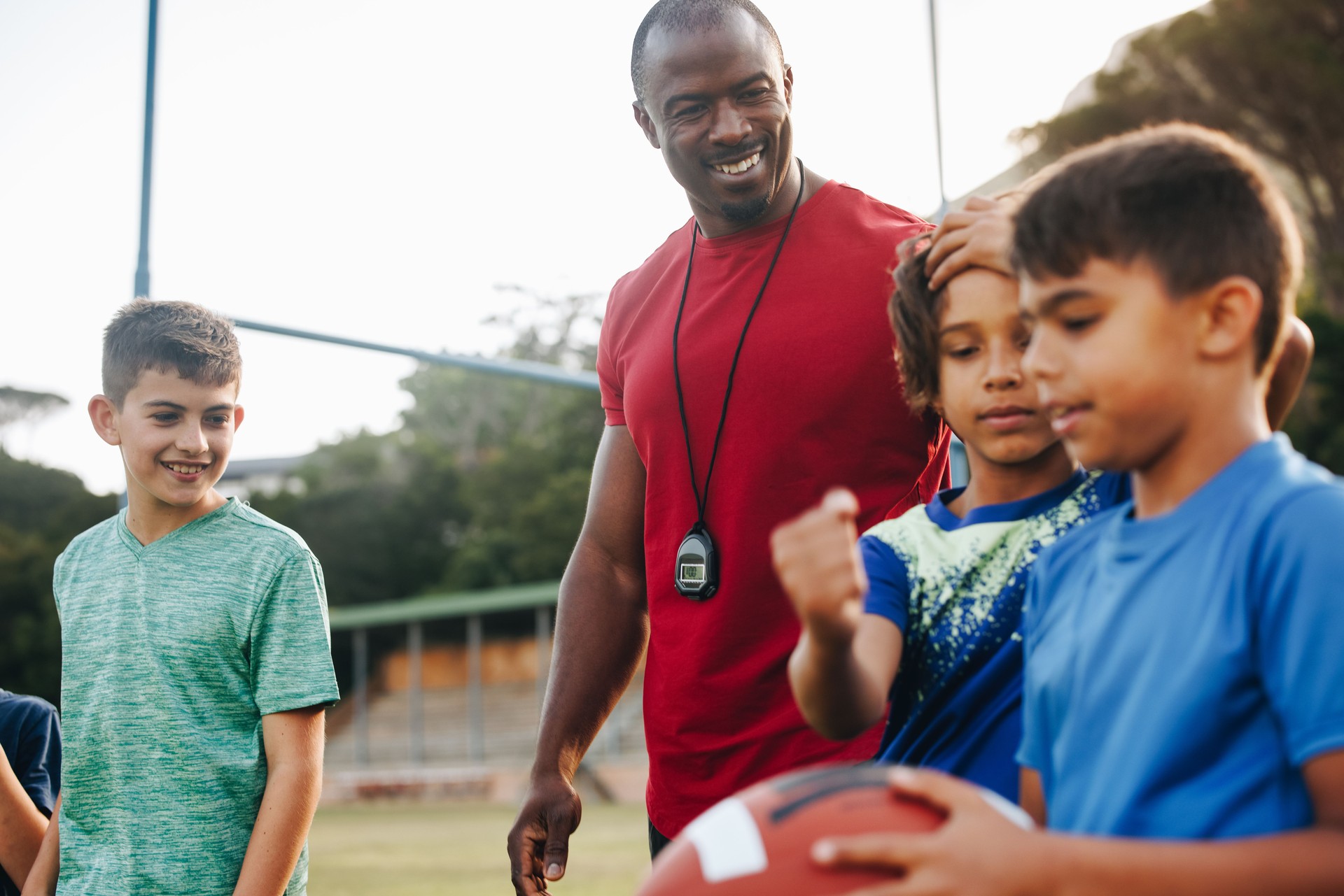 Coach training an elementary school football team